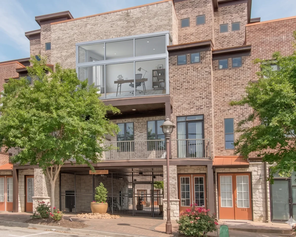 Brick townhouses with a glass enclosed balcony above ground floor entries