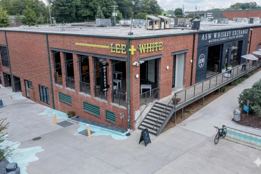 An aerial view of a converted brick warehouse district with shopfronts and a painted plaza