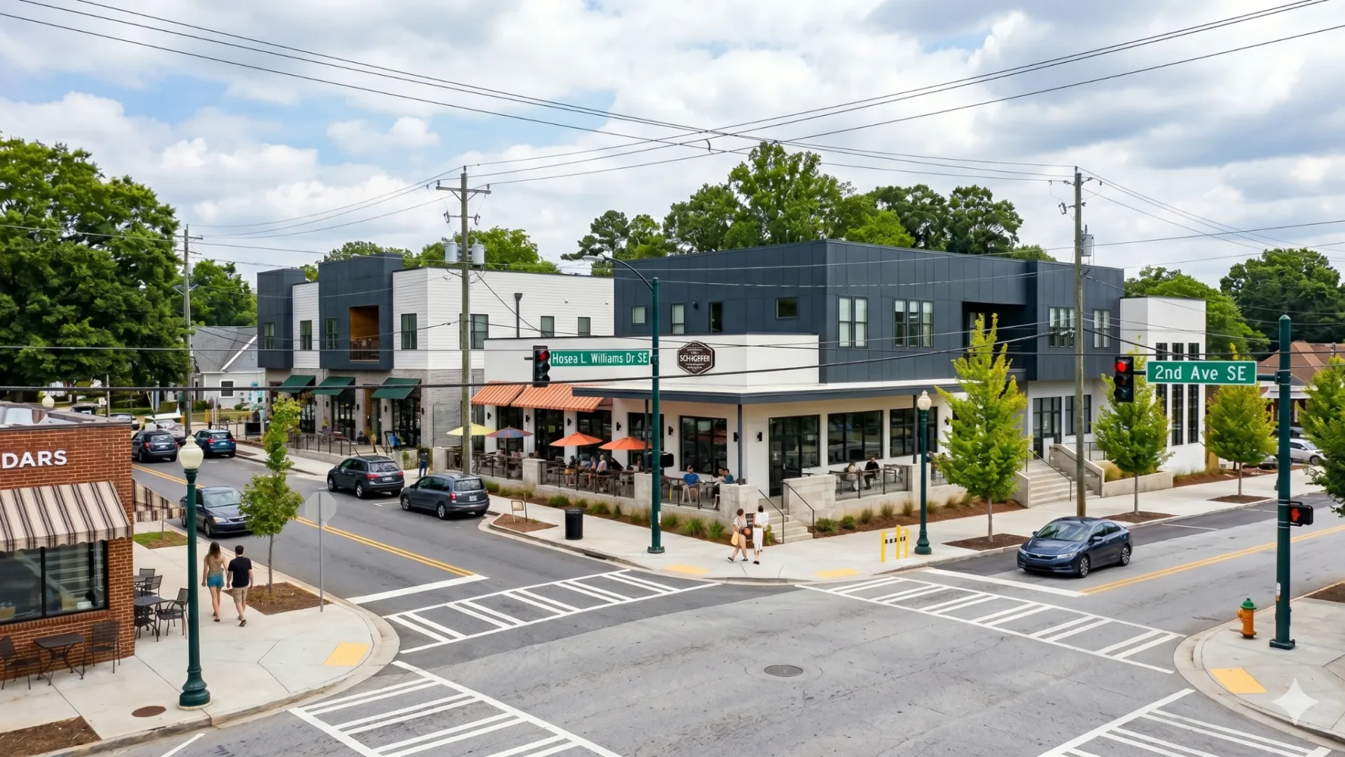 A small commercial crossroads with shopfronts and parked cars