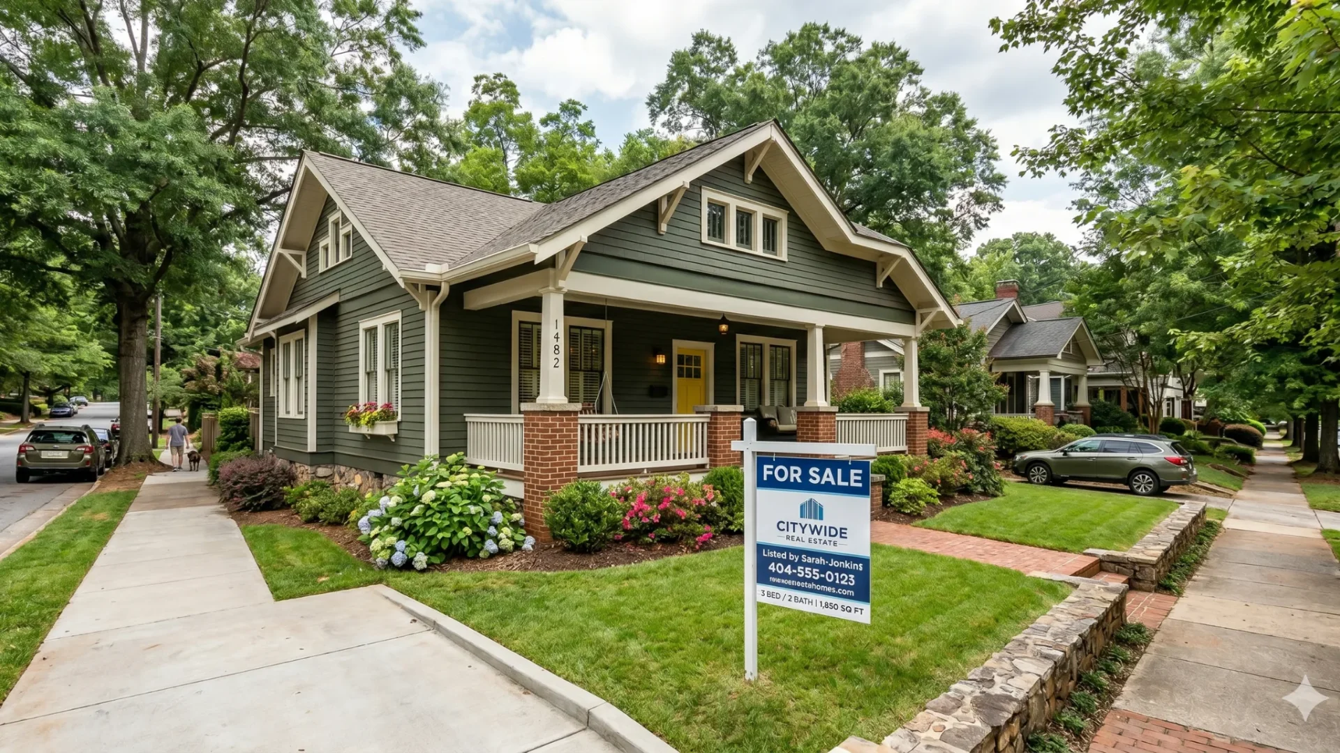 A Craftsman bungalow with a for-sale sign in the front yard
