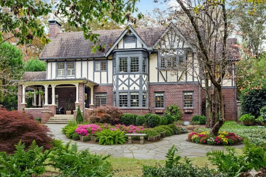 Brick and stucco Tudor with half-timbering and a stone terrace