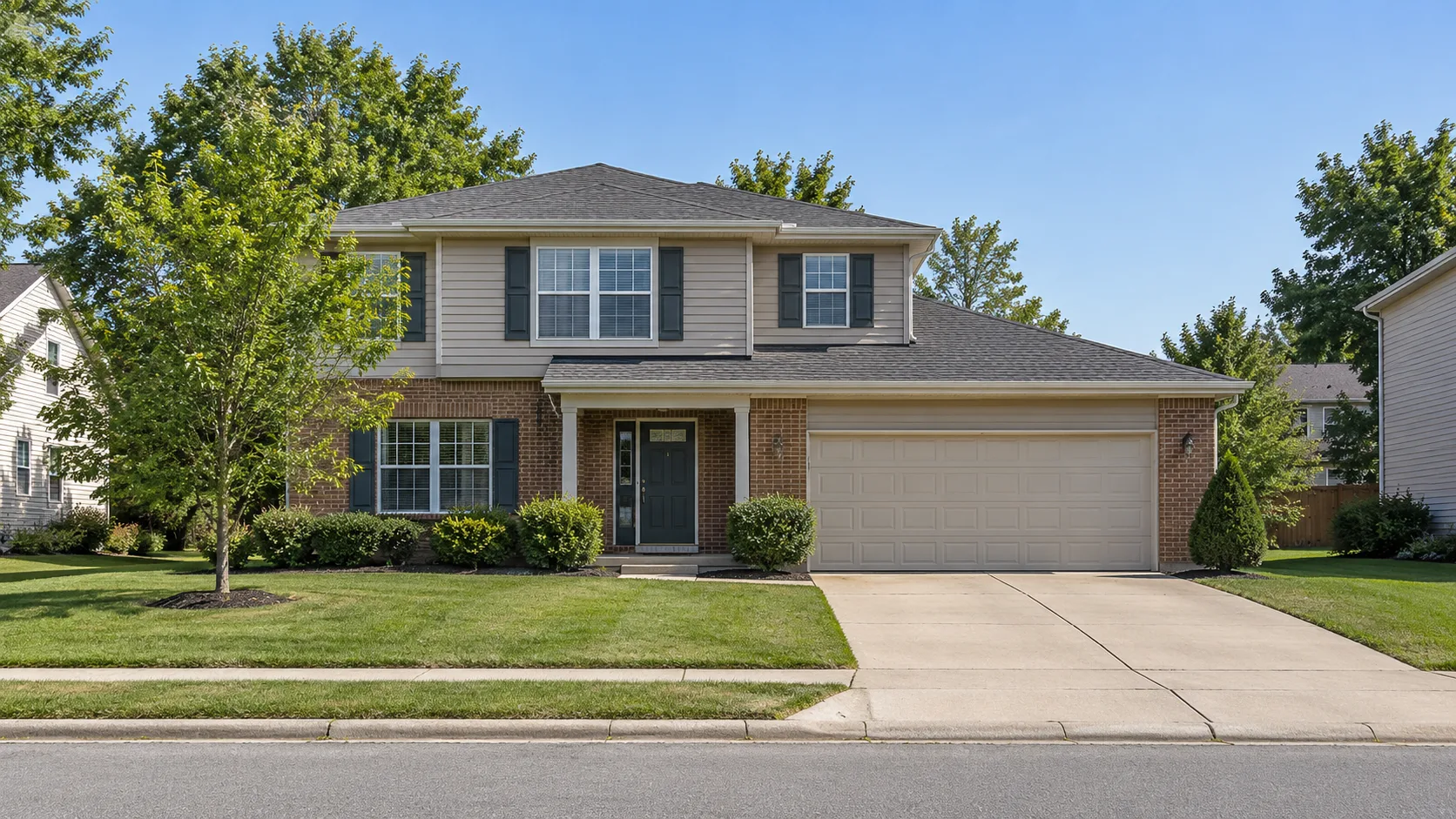 A mid market suburban two storey house in brick and beige siding with a two car garage and a plain tidy lawn in flat midday light