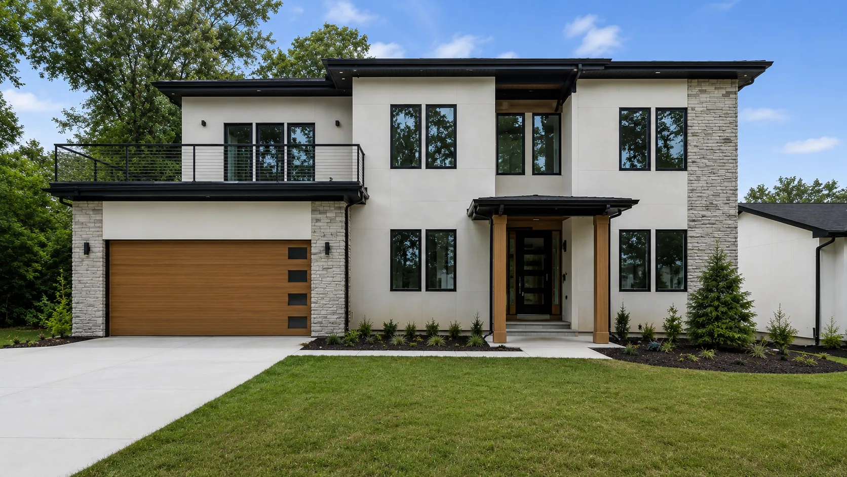 A modern white stucco and stone house with a wood garage door and a wide concrete drive