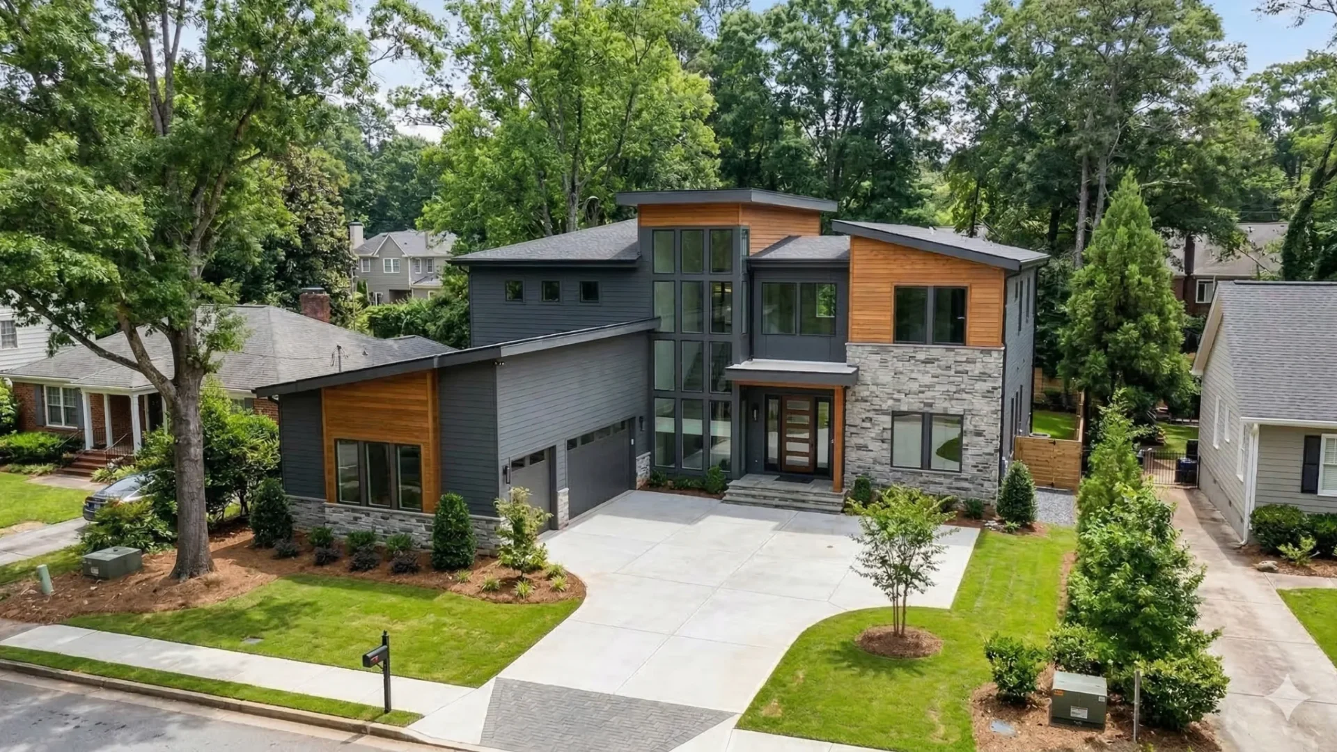 A modern wood and stone house with a wide paved drive