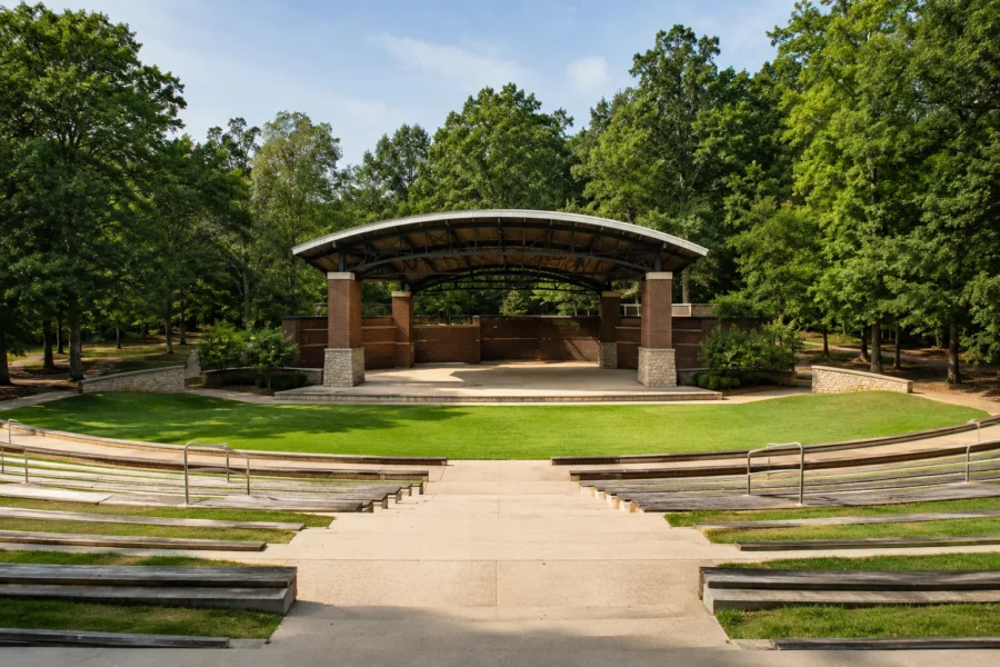 A park amphitheatre with a curved canopy over the stage and tiered steps