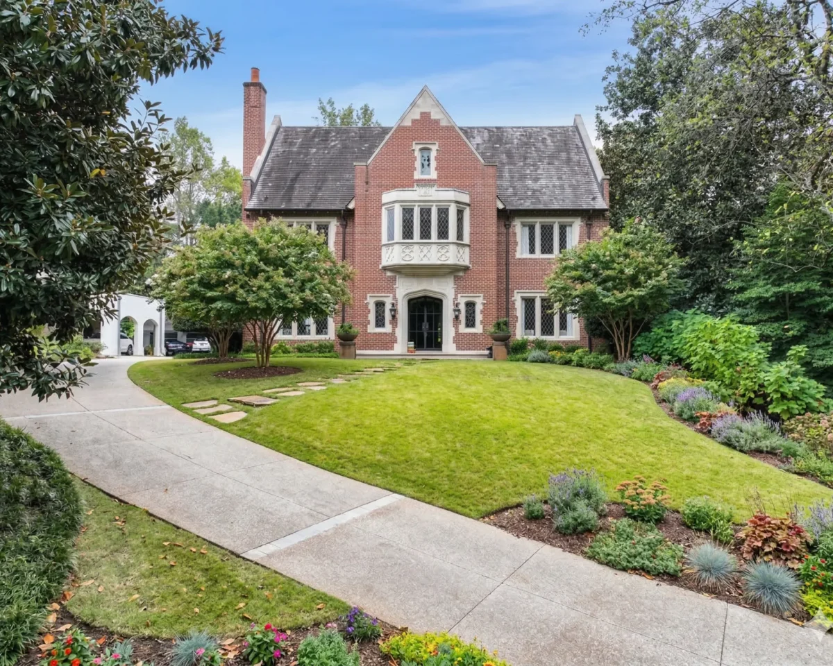 Pink brick colonial revival with a slate roof and a curved front walk