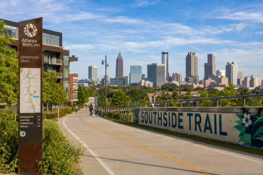 A trail marker and painted Southside Trail sign with the skyline behind