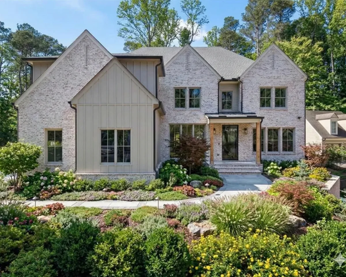 A white brick modern farmhouse above a terraced garden of layered planting
