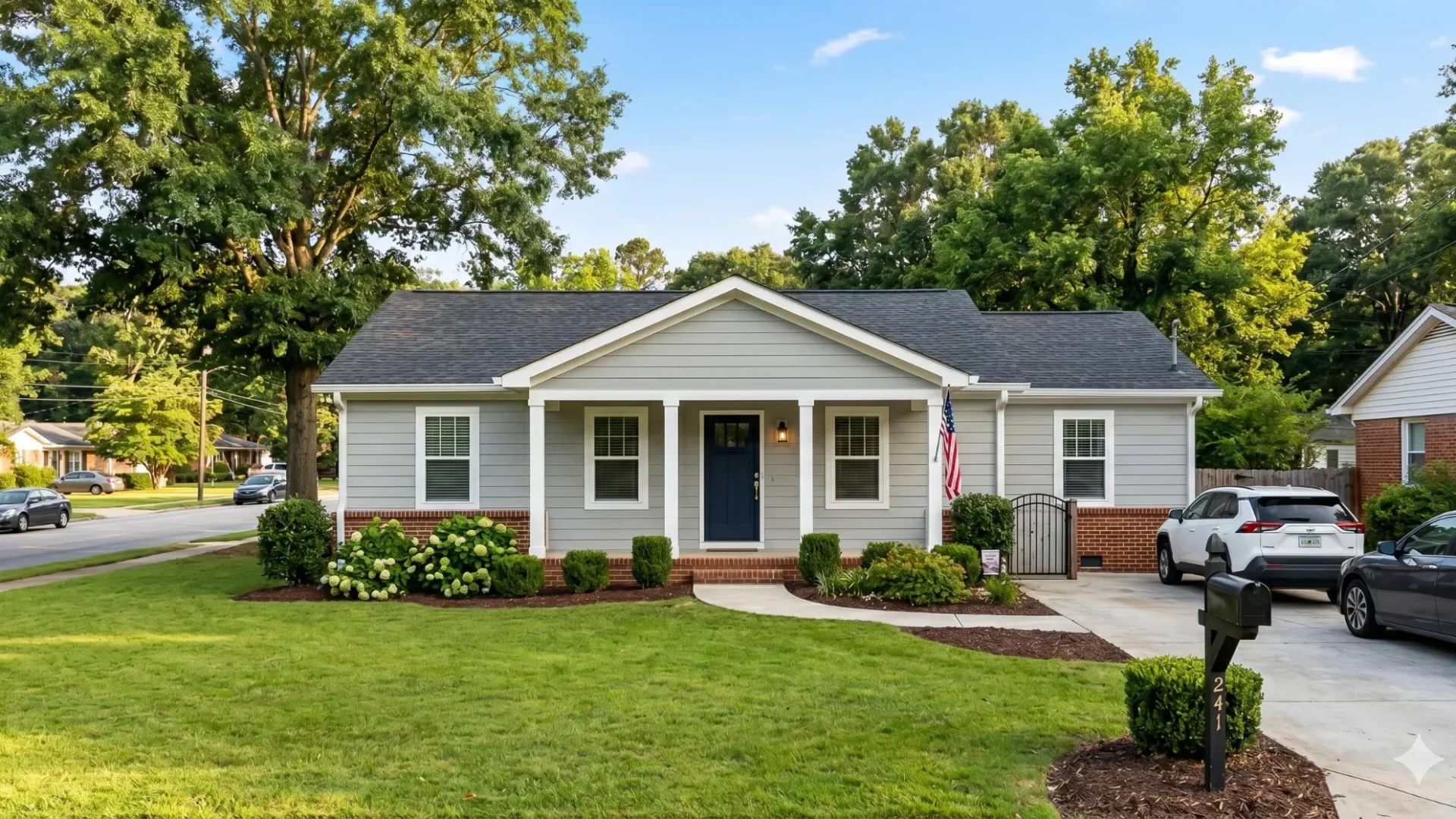 A white ranch house with a dark front door, a carport and a front lawn