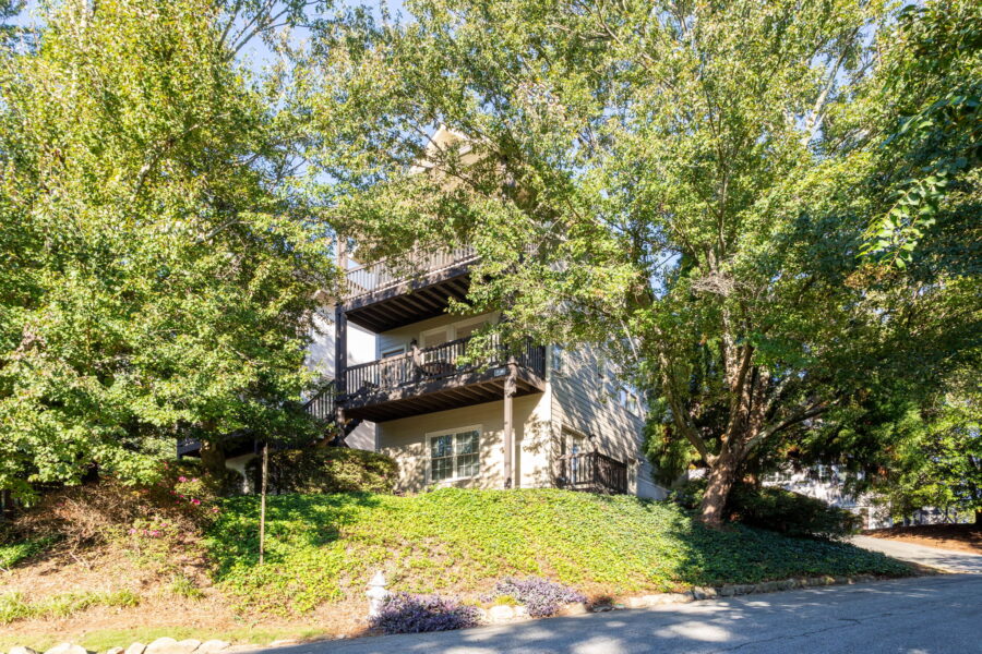 Townhome exterior with balconies among mature trees